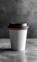 Warm drink in cozy space. A takeout cup sits on a textured surface, conveying a sense of warmth and comfort in a serene setting. photo