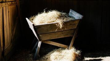Manger Scene Rustic Wooden Trough Filled with Hay in a Dark Barn a Symbol of Humility and New Beginnings photo