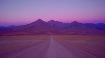 Purple Haze A Road Through the Desert Mountains Under a Twilight Sky photo