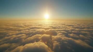 Golden Horizon Sun Above a Sea of Clouds Bathed in Warm Light a Tranquil Aerial Perspective photo