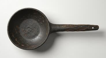A large frying pan with a handle on a white surface photo