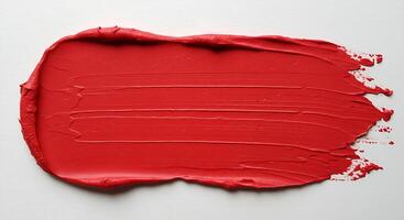 A red paint splatter on a white surface photo