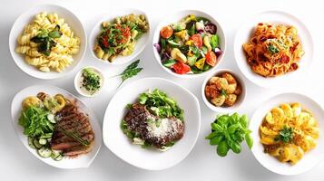 A variety of different dishes are arranged on white plates photo