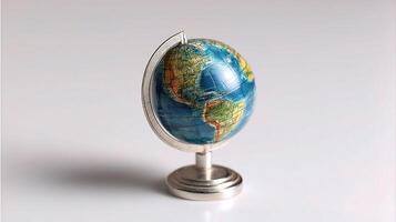 A small globe on a stand with a silver base photo