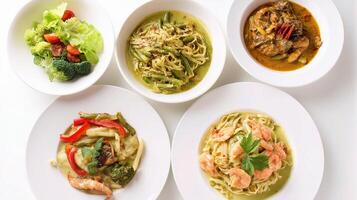 A set of four white plates with different types of food photo