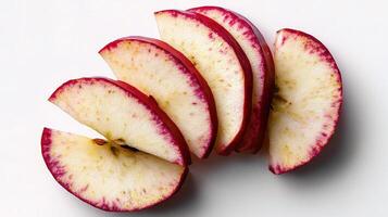 A bunch of sliced apples on a white surface photo