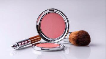 A compact blush powder and brush on a white surface photo