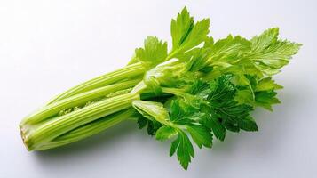 A bunch of celery on a white surface photo