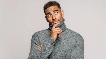 A man in a sweater is thinking photo