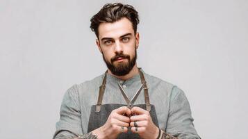 A man with a beard and apron holding scissors photo
