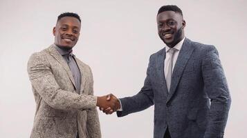 Two men shaking hands in front of a white background photo
