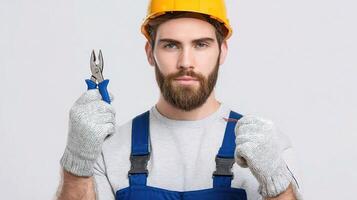 A man with a beard and a hard hat holding a pair of pliers photo