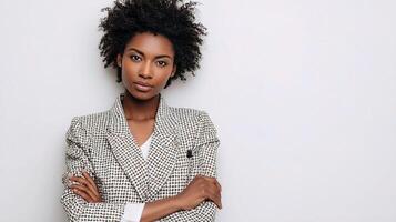 A woman with an afro is standing with her arms crossed photo