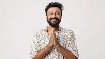 A man with a beard and a floral shirt is smiling photo