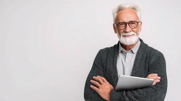 An old man with glasses and a beard holding a tablet photo