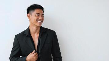 Asian man in black suit smiling photo