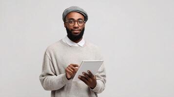 A man with a beard and glasses is holding a tablet photo