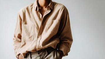 A man in a tan shirt and khaki pants photo