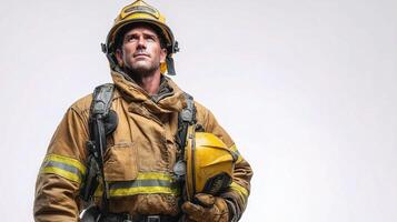 A firefighter in a yellow helmet and uniform photo