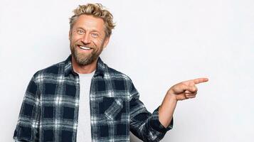 A man with a beard and a plaid shirt is pointing at something photo