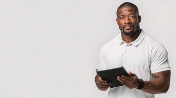 A man holding a tablet and looking at it photo