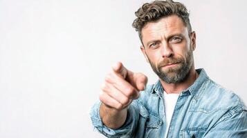 A man with a beard pointing at something photo