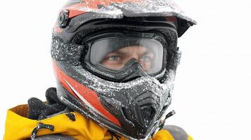 A man wearing a helmet and a jacket in the snow photo