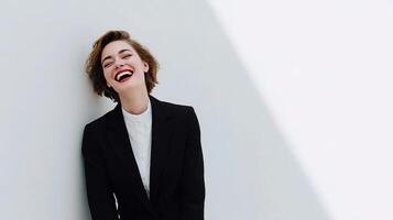 A woman in a suit and tie is smiling photo