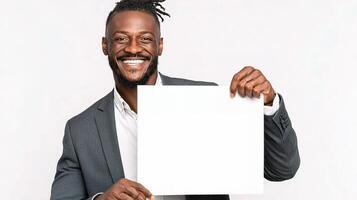 A smiling black man holding up a blank white board photo