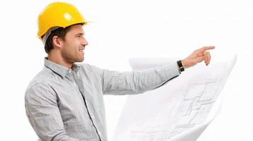 A man in a hard hat pointing at a blueprint photo
