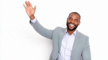 A smiling black man in a suit waving his hand photo
