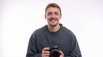 A man holding a camera and smiling photo