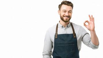 A man in an apron is making an ok sign photo