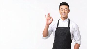 A man in an apron is making the ok sign photo