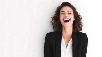 A woman laughing in a suit and white shirt photo