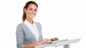 A woman is sitting at a desk with a laptop photo