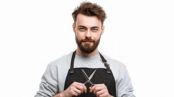 A man with a beard and a black apron holding scissors photo