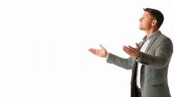 A man in a suit is standing with his hands out photo