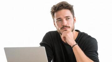 A man sitting at a desk with his hand on his chin photo