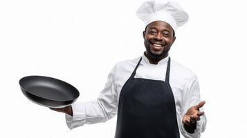 A smiling black man in a chef's hat holding a frying pan photo