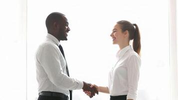 Two business people shaking hands in an office photo