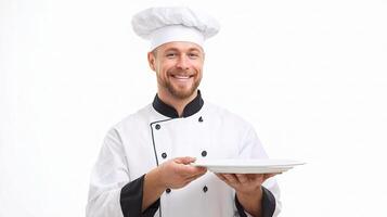 A smiling man in a chef's uniform holding a plate photo