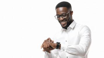 A man in glasses is smiling and looking at his watch photo