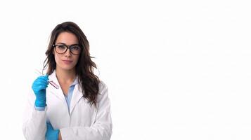 A woman in a lab coat and gloves holding a blue glove photo