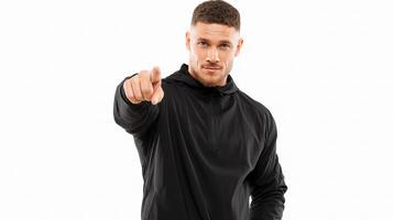 A man in a black sweatshirt pointing at something photo