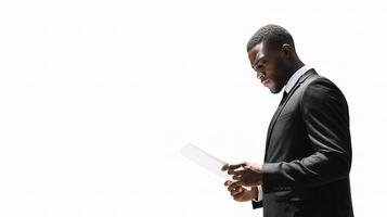 A man in a suit is holding a piece of paper photo