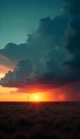 A sunset over a field with clouds and a light photo