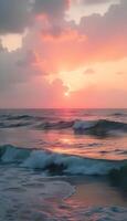 A sunset over the ocean with waves and clouds photo