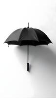 An open black umbrella on a white background photo