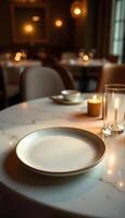 Empty plate on table in restaurant with candles photo